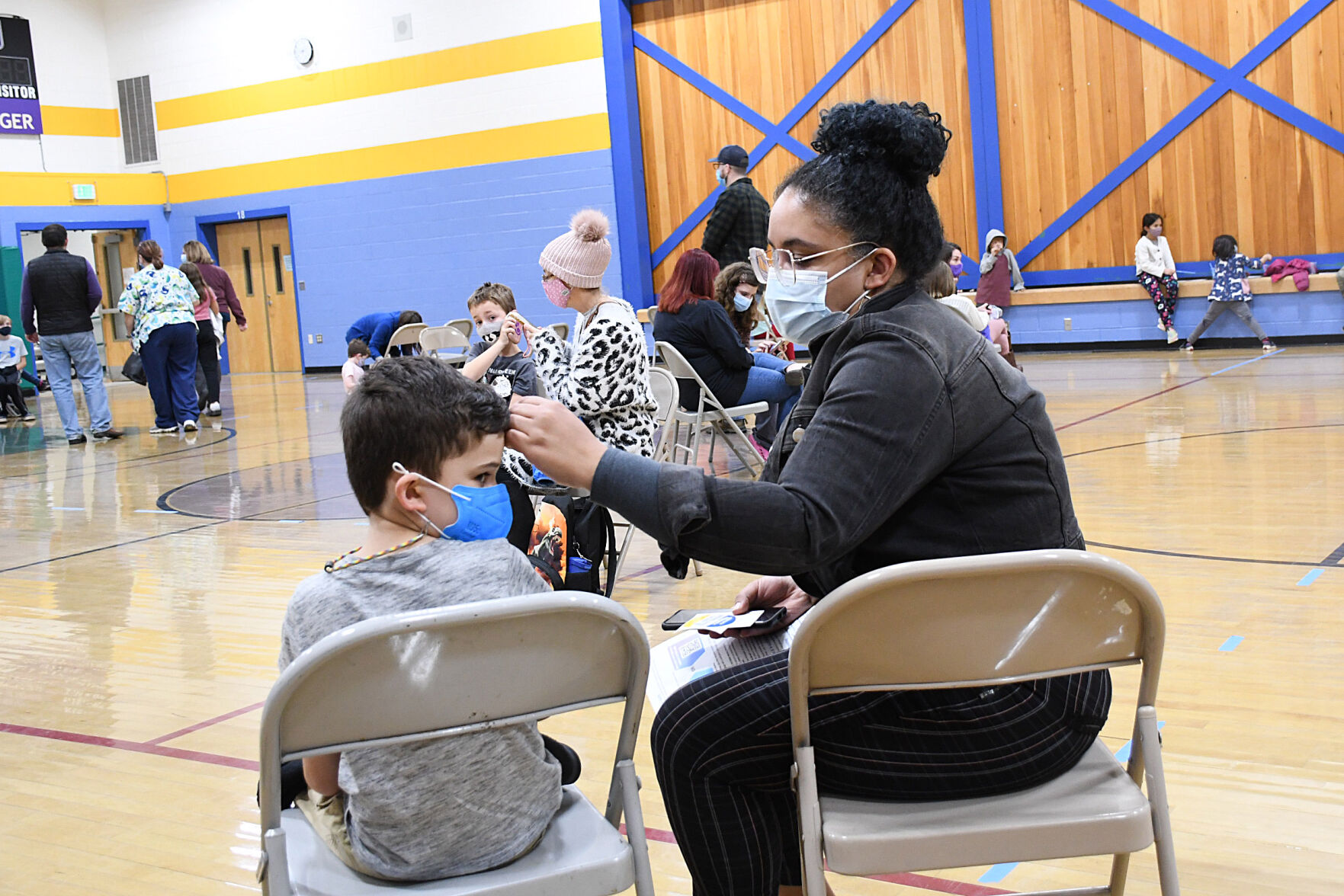 Eli and his mom wait the 15 minutes after receiving his vaccine